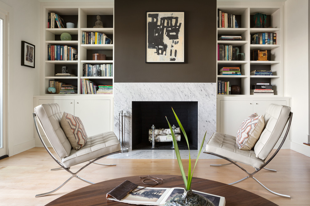 Idee per un soggiorno design di medie dimensioni con libreria, pareti multicolore, parquet chiaro e camino classico