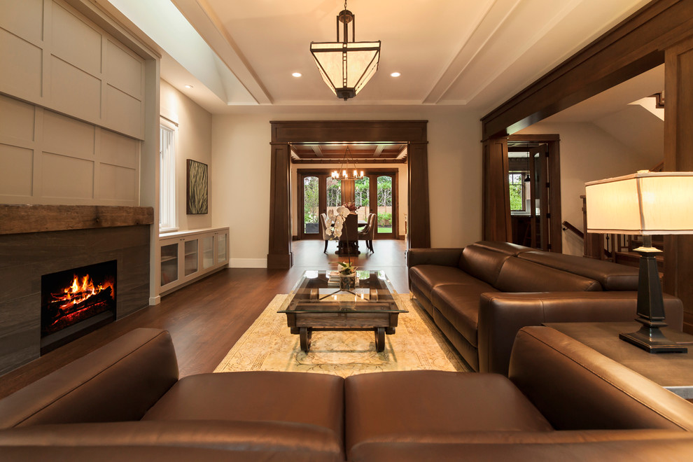 Example of a mid-sized classic formal and open concept dark wood floor living room design in Vancouver with beige walls, a standard fireplace, a stone fireplace and no tv