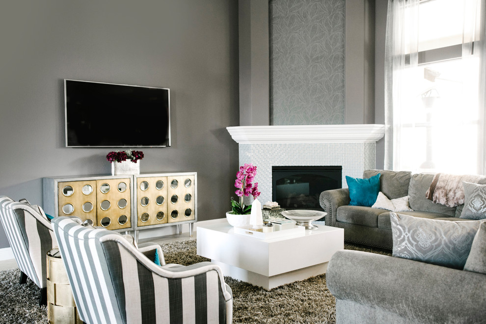 Example of a mid-sized trendy formal and enclosed travertine floor and beige floor living room design in Columbus with gray walls, a wall-mounted tv, a corner fireplace and a tile fireplace