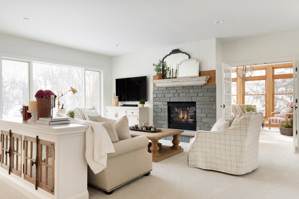Example of a farmhouse open concept carpeted and beige floor living room design in Minneapolis with white walls, a standard fireplace and a stone fireplace