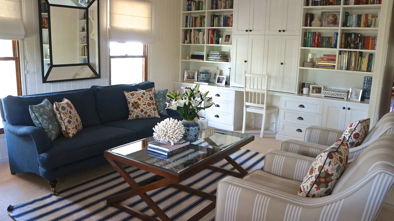 This is an example of a medium sized bohemian formal open plan living room in Brisbane with white walls, carpet, no fireplace and a freestanding tv.