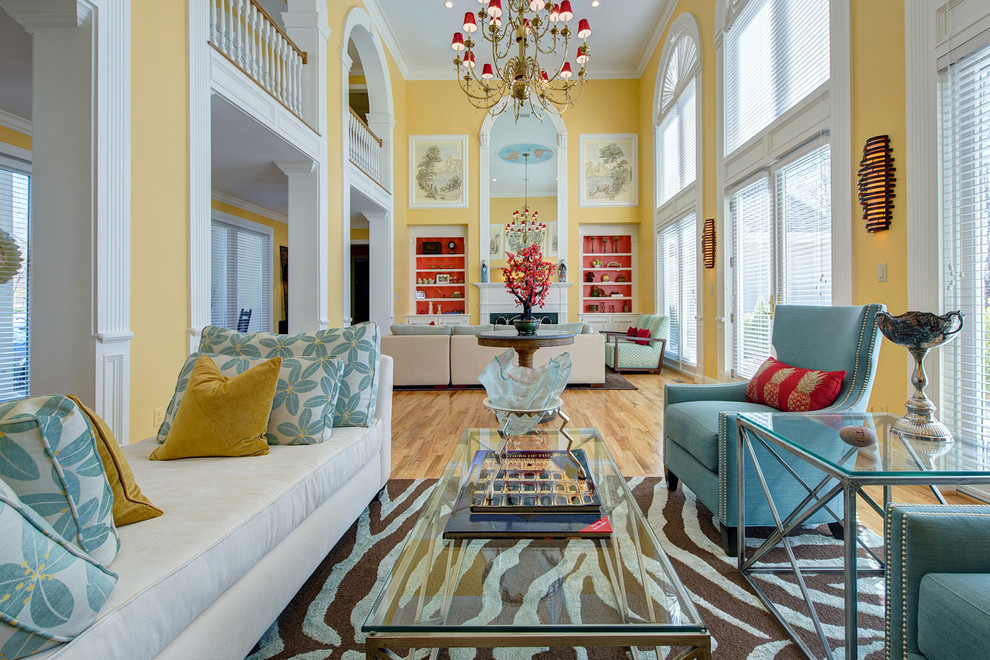 Пример оригинального дизайна: большая открытая гостиная комната:: освещение в современном стиле с желтыми стенами, светлым паркетным полом, стандартным камином и коричневым полом