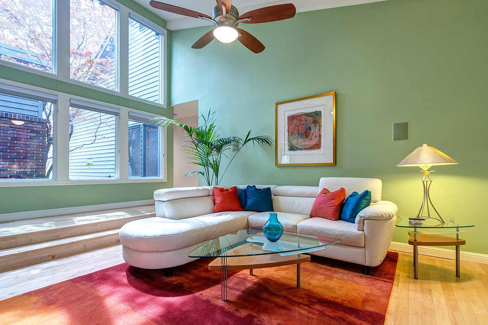 Photo of a contemporary living room in St Louis with green walls.