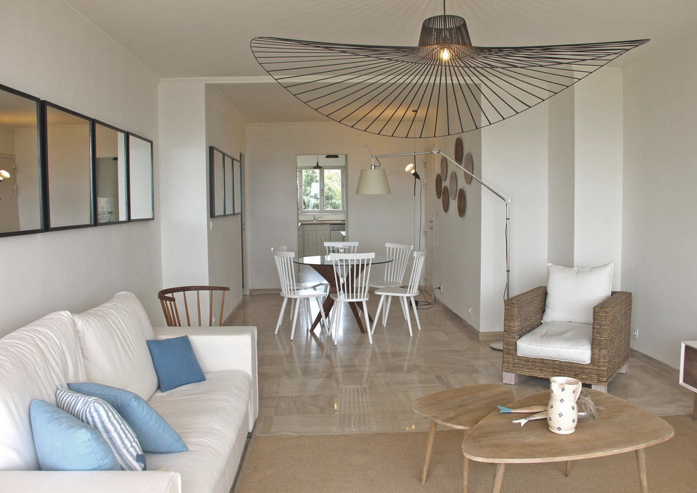 Inspiration for a beach style living room in Milan with white walls.