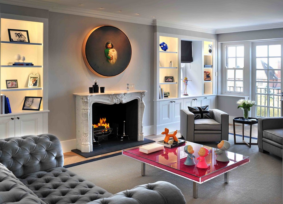 Mid-sized trendy formal light wood floor living room photo in London with gray walls and a standard fireplace