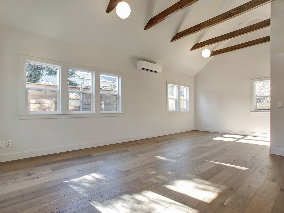 Example of a small minimalist open concept light wood floor living room design in Portland with white walls