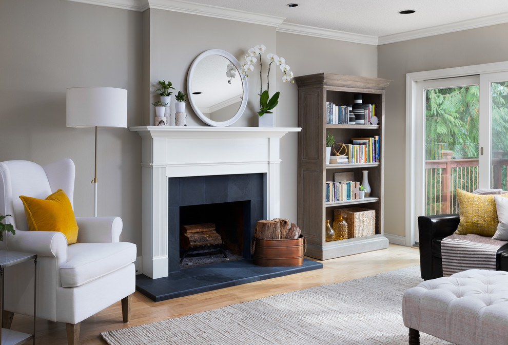 Design ideas for a medium sized traditional enclosed living room in Portland with grey walls, light hardwood flooring, a standard fireplace, a tiled fireplace surround and no tv.