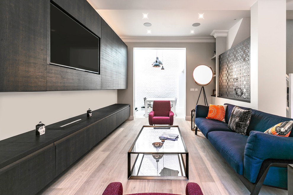 Photo of a medium sized contemporary enclosed living room in London with grey walls, light hardwood flooring, a built-in media unit and beige floors.