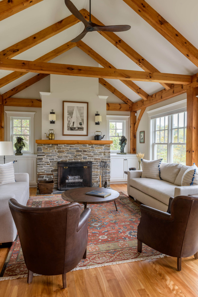 This is an example of a large classic formal open plan living room in Burlington with a stone fireplace surround, beige walls, medium hardwood flooring, a standard fireplace, no tv and brown floors.