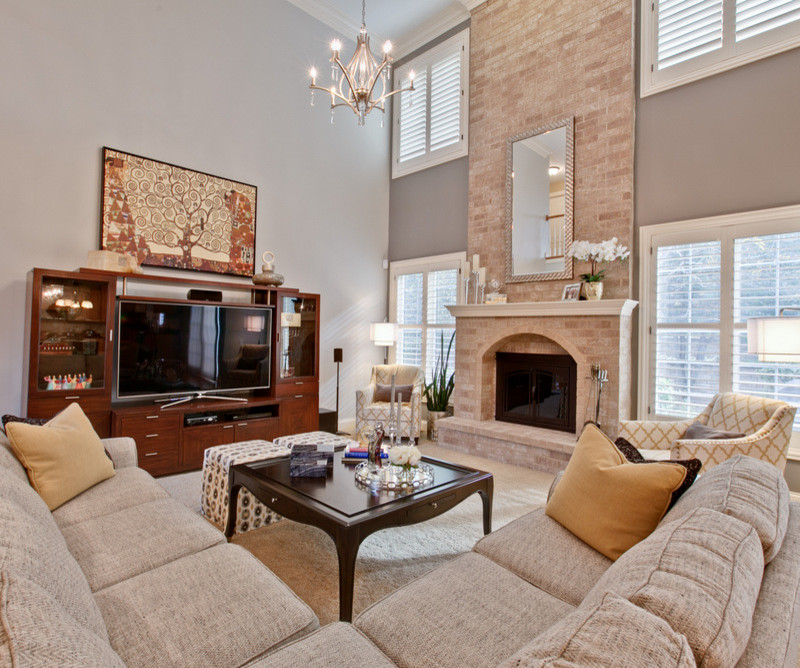 Inspiration for a mid-sized transitional open concept carpeted living room remodel in Chicago with gray walls, a standard fireplace, a brick fireplace and a tv stand