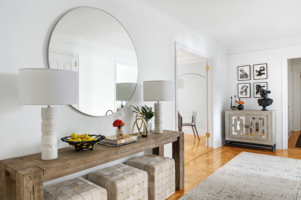 Example of a small trendy medium tone wood floor and brown floor living room design in New York with white walls