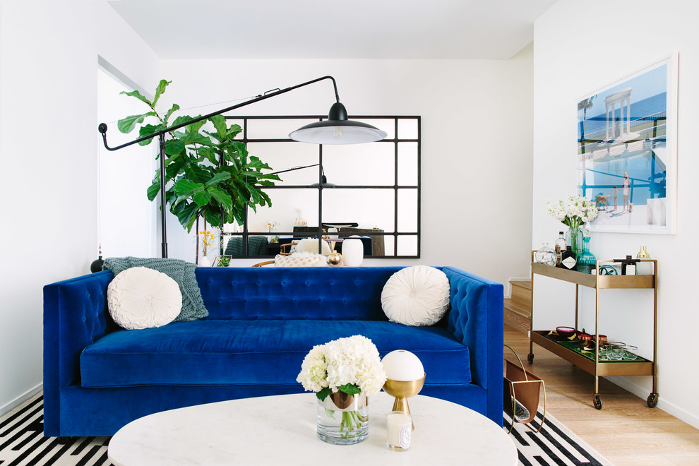 Example of a trendy light wood floor living room design in Los Angeles with white walls