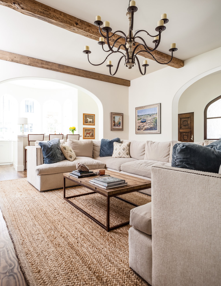 Example of a tuscan living room design in Dallas with white walls