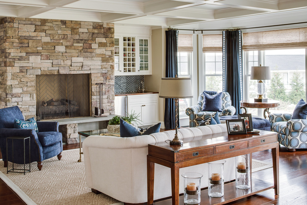 Example of a beach style living room design in Portland Maine with a stone fireplace