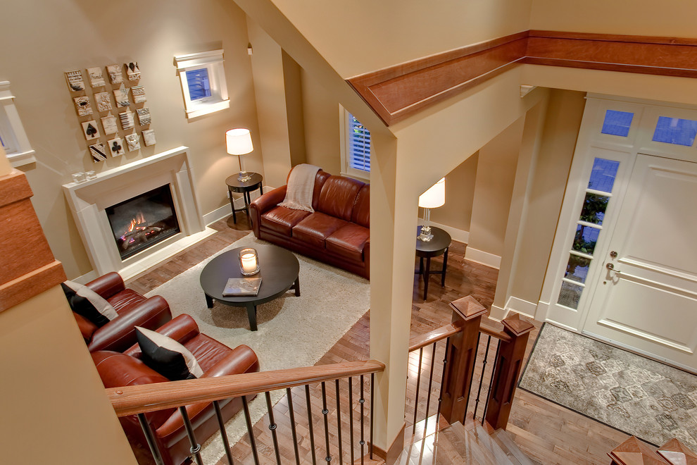 Exemple d'un salon tendance avec un mur beige, une cheminée standard et un escalier.