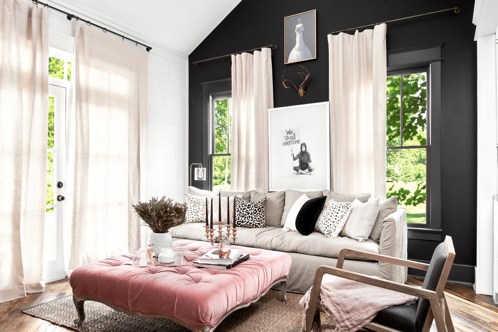 Photo of a traditional living room feature wall in Nashville with black walls and dark hardwood flooring.