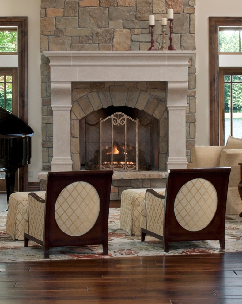 Example of a huge classic formal and open concept dark wood floor living room design in Other with beige walls, a standard fireplace, a stone fireplace and a concealed tv