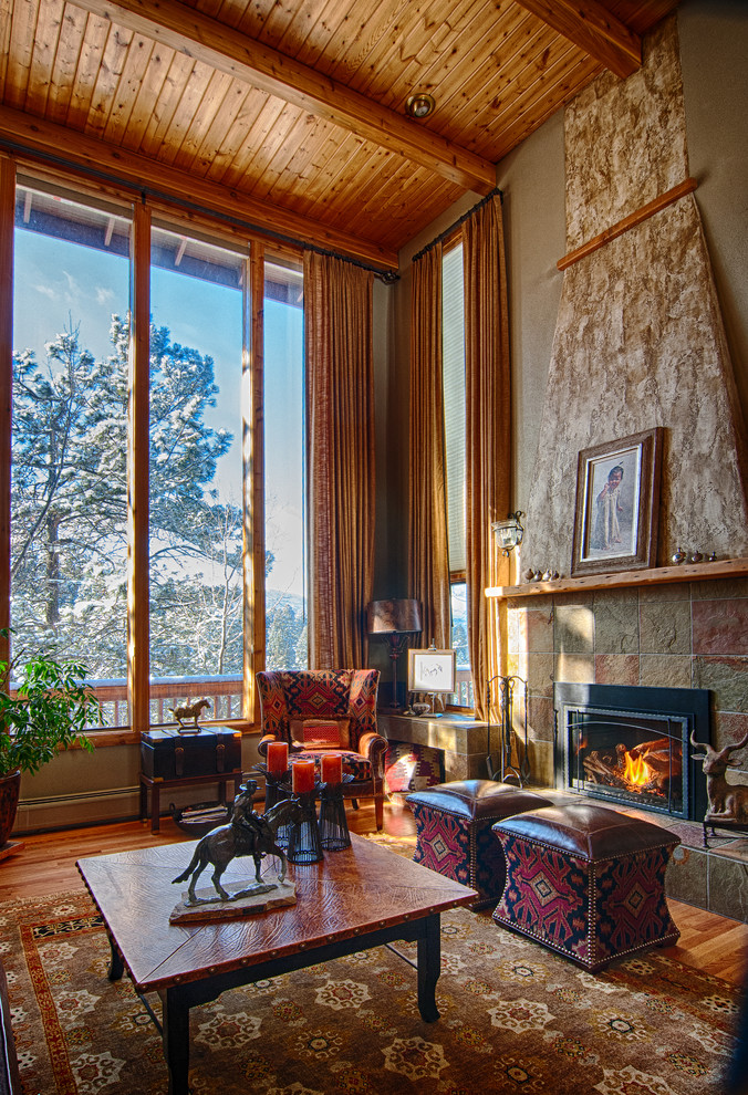 Cette photo montre un grand salon montagne avec une salle de réception, un mur beige, une cheminée standard et un manteau de cheminée en pierre.