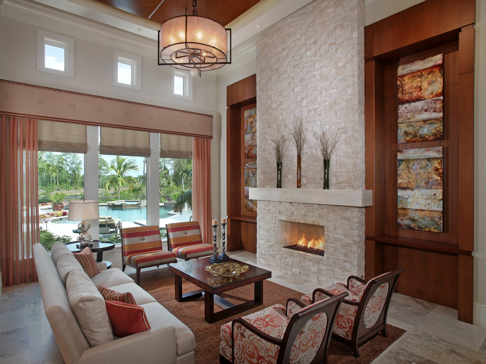 This is an example of a classic formal enclosed living room in Miami with white walls, a ribbon fireplace, a stone fireplace surround, no tv and grey floors.