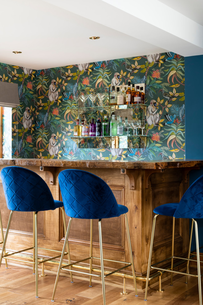 Inspiration for a large eclectic home bar in Cambridgeshire with medium hardwood flooring and brown floors.