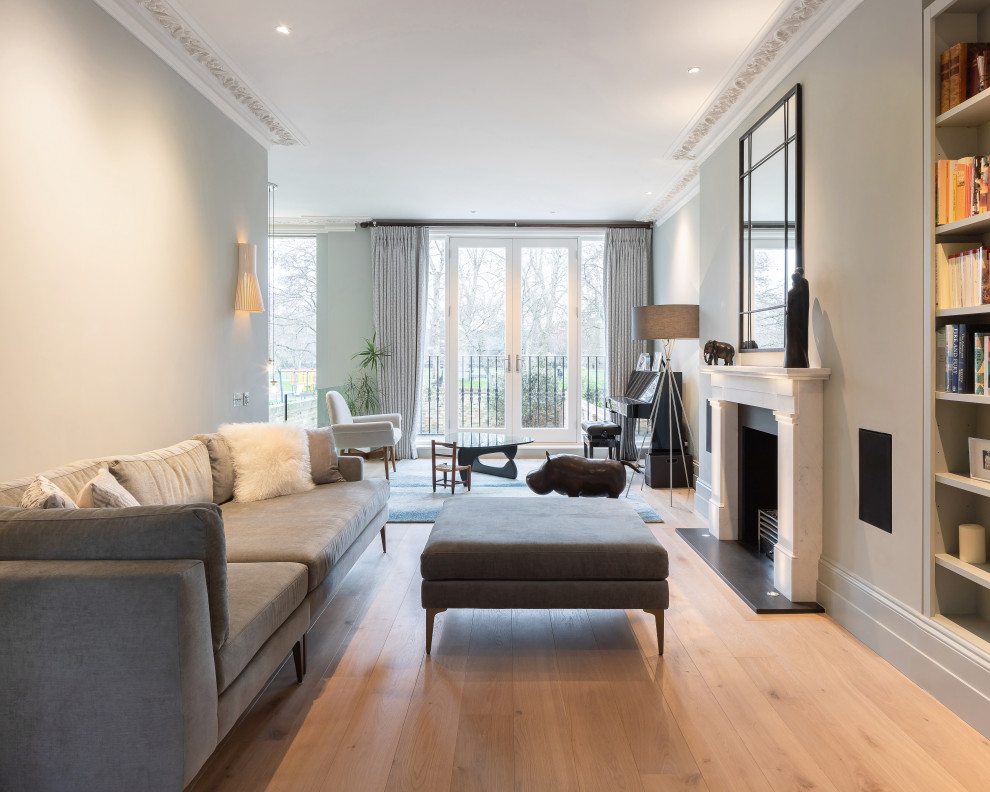 Example of a transitional formal and open concept medium tone wood floor and brown floor living room design in Other with gray walls, a standard fireplace and no tv