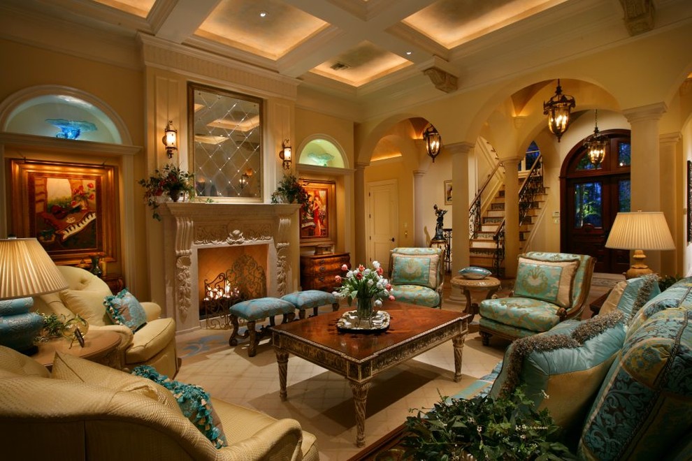 Photo of a mediterranean living room in Miami with a standard fireplace, a stone fireplace surround and yellow walls.
