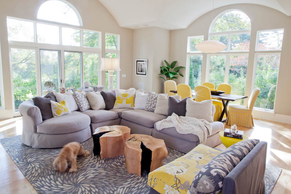 Design ideas for a contemporary grey and yellow open plan living room in Miami with beige walls and light hardwood flooring.