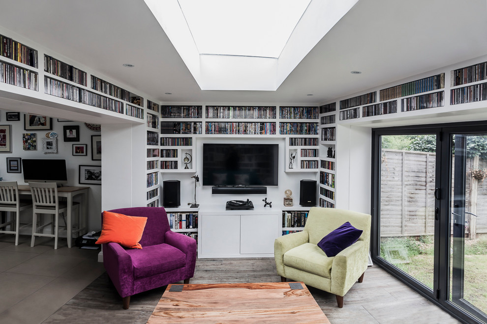 This is an example of a medium sized eclectic living room in London with a music area, white walls, ceramic flooring and a wall mounted tv.