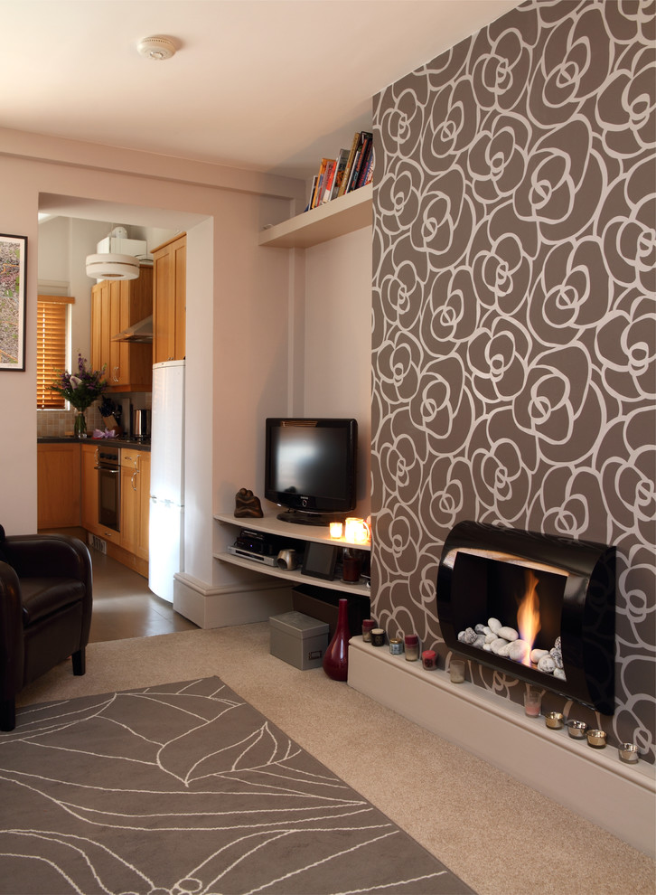 Photo of a small contemporary formal open plan living room in London with brown walls, carpet, a two-sided fireplace, a metal fireplace surround and a freestanding tv.