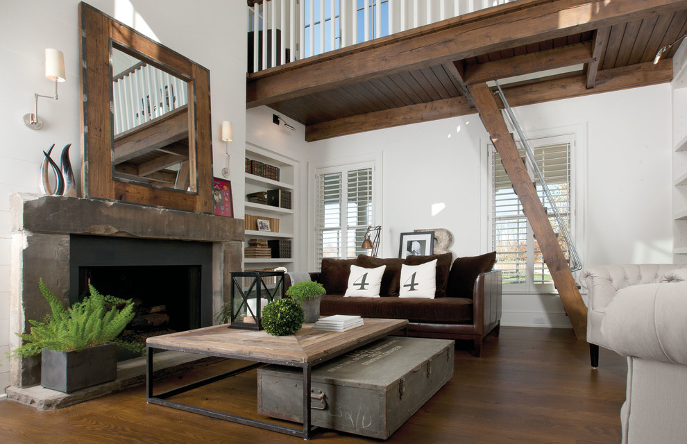 Inspiration for a mid-sized rustic dark wood floor and brown floor living room remodel in Columbus with white walls, a standard fireplace and a wood fireplace surround