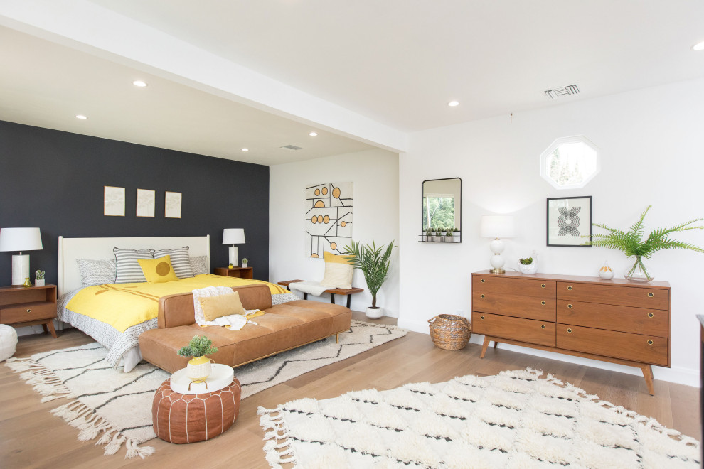 Offenes Modernes Wohnzimmer mit schwarzer Wandfarbe, braunem Holzboden und braunem Boden in Los Angeles