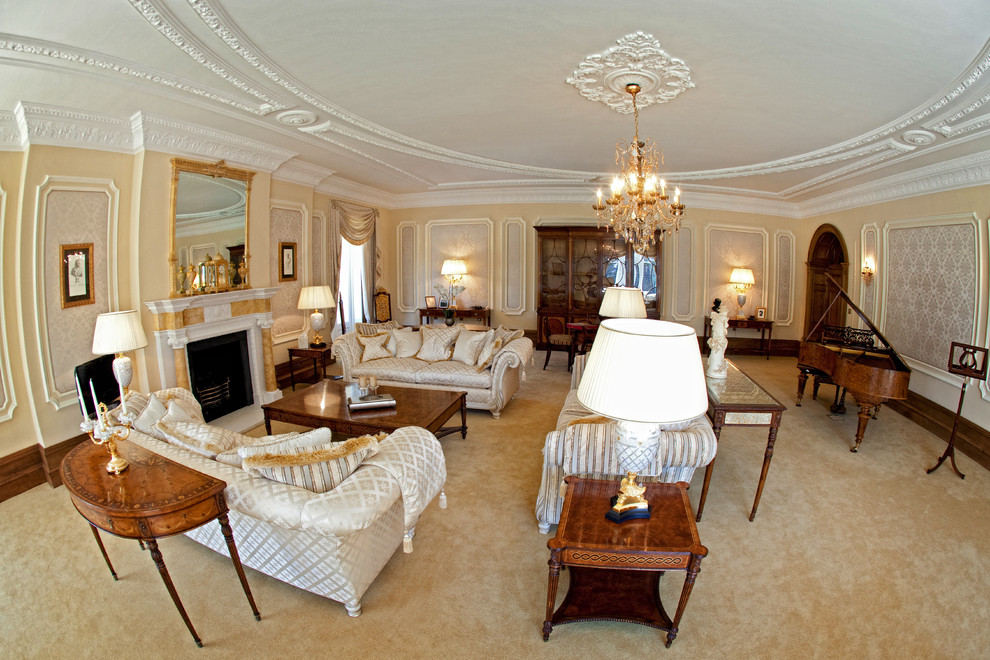 Example of a large classic formal carpeted and yellow floor living room design in London with beige walls, a standard fireplace and a stone fireplace
