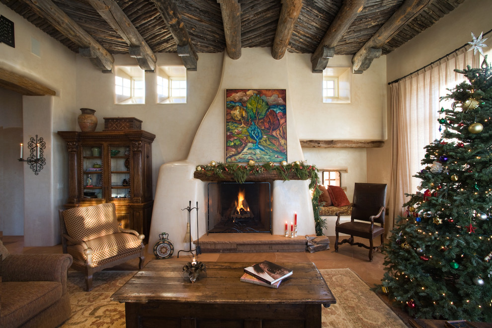 Example of a mid-sized tuscan formal and open concept slate floor living room design in Albuquerque with white walls, a standard fireplace, a plaster fireplace and no tv