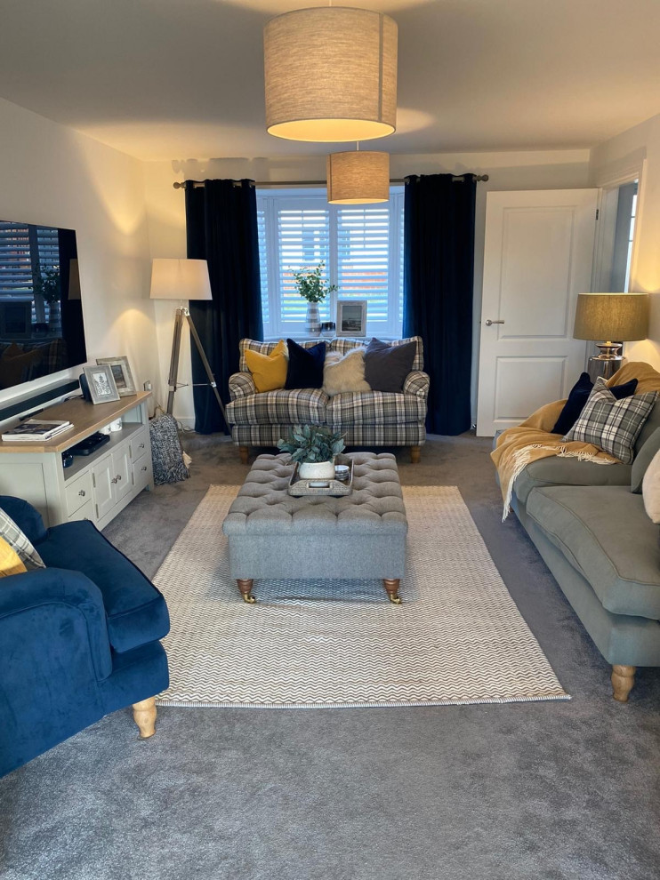 Photo of a medium sized country formal enclosed living room in Hampshire with white walls, carpet, no fireplace, a wall mounted tv and grey floors.