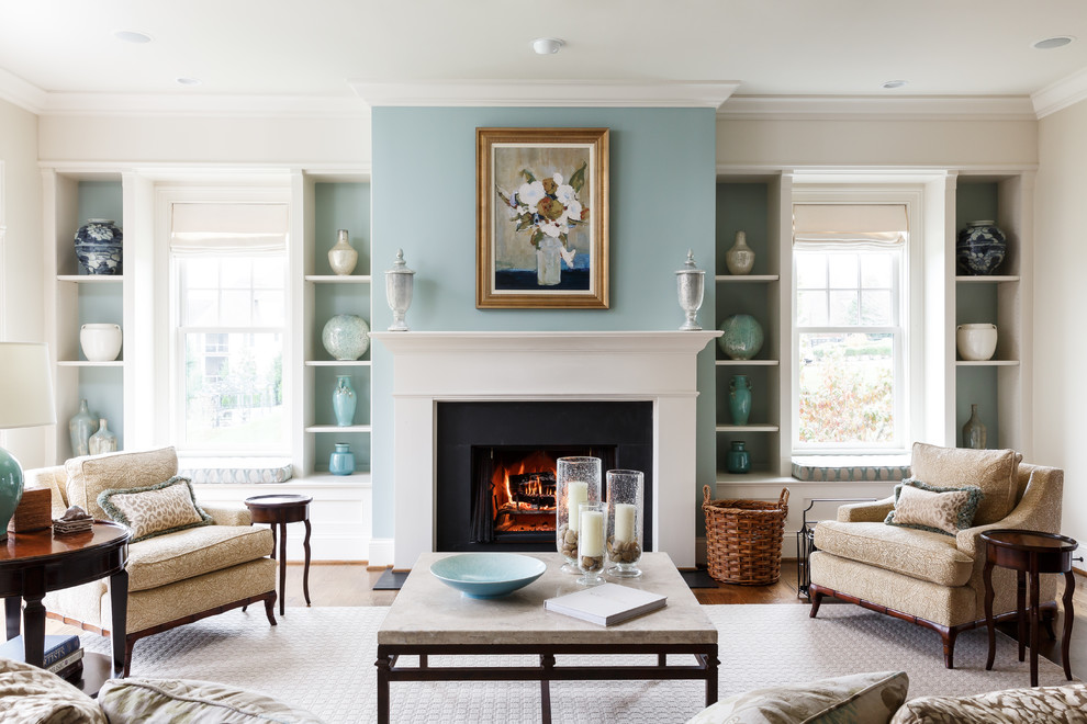 Inspiration for a classic living room in Louisville with blue walls, medium hardwood flooring, a standard fireplace and brown floors.