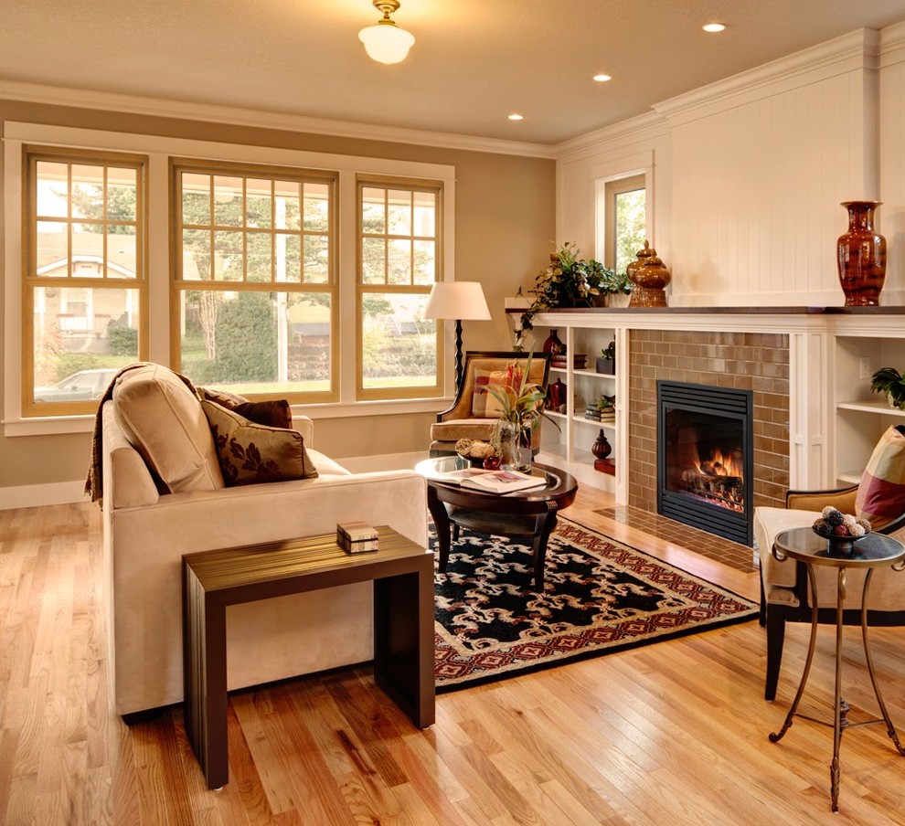 Mid-sized transitional formal and enclosed light wood floor and brown floor living room photo in Cleveland with beige walls, a standard fireplace, a tile fireplace and no tv