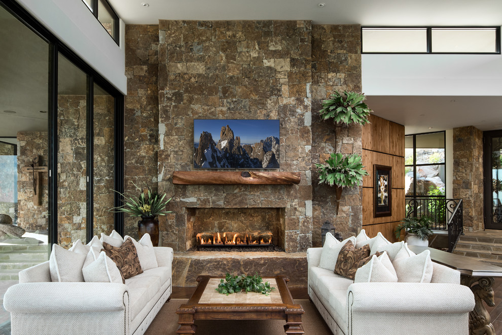 Inspiration for a large contemporary open plan living room in Phoenix with a music area, brown walls, dark hardwood flooring, a standard fireplace, a stone fireplace surround, a wall mounted tv and brown floors.