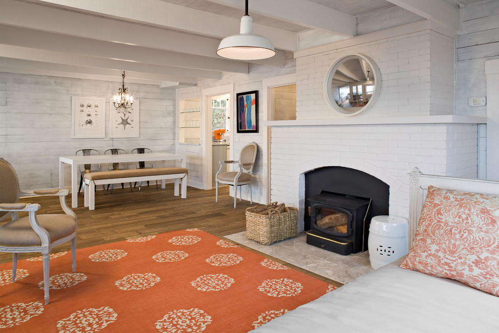 Photo of a bohemian living room in Seattle with white walls and a wood burning stove.