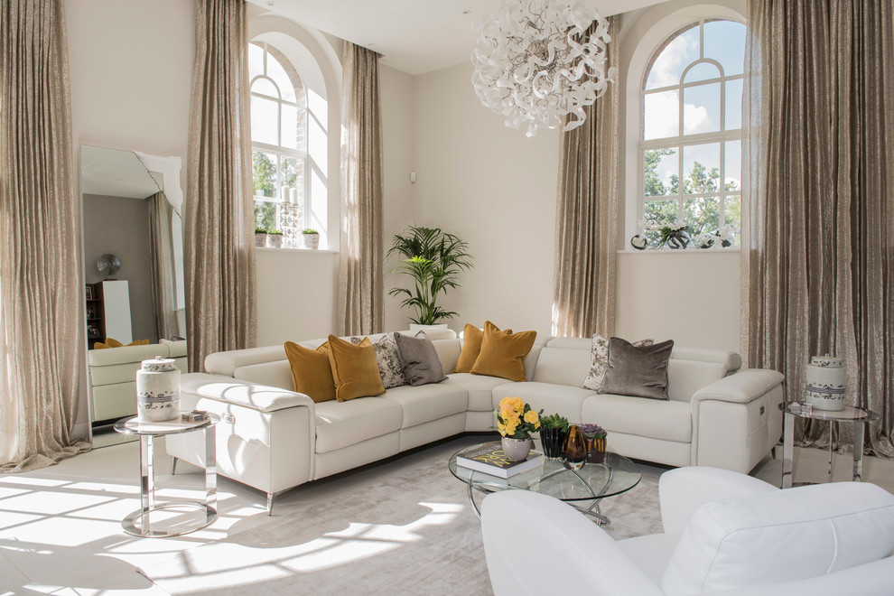 This is an example of a traditional formal open plan living room in London with beige walls and carpet.