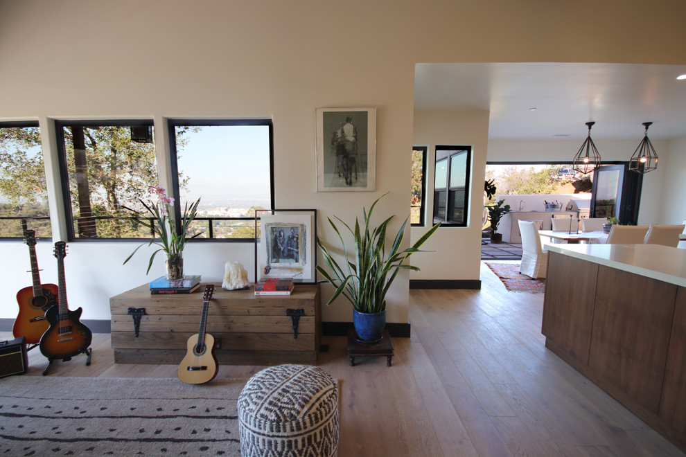 Immagine di un grande soggiorno eclettico aperto con sala formale, pareti bianche, pavimento in legno massello medio e pavimento beige