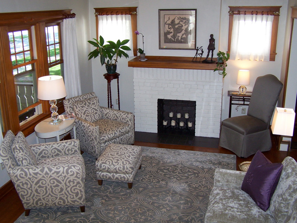 Design ideas for a medium sized traditional formal enclosed living room in Cincinnati with beige walls, medium hardwood flooring, a standard fireplace, a brick fireplace surround and no tv.