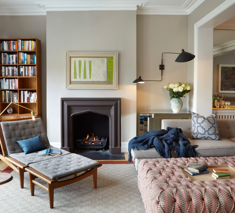 Photo of a contemporary living room in London with grey walls and a standard fireplace.