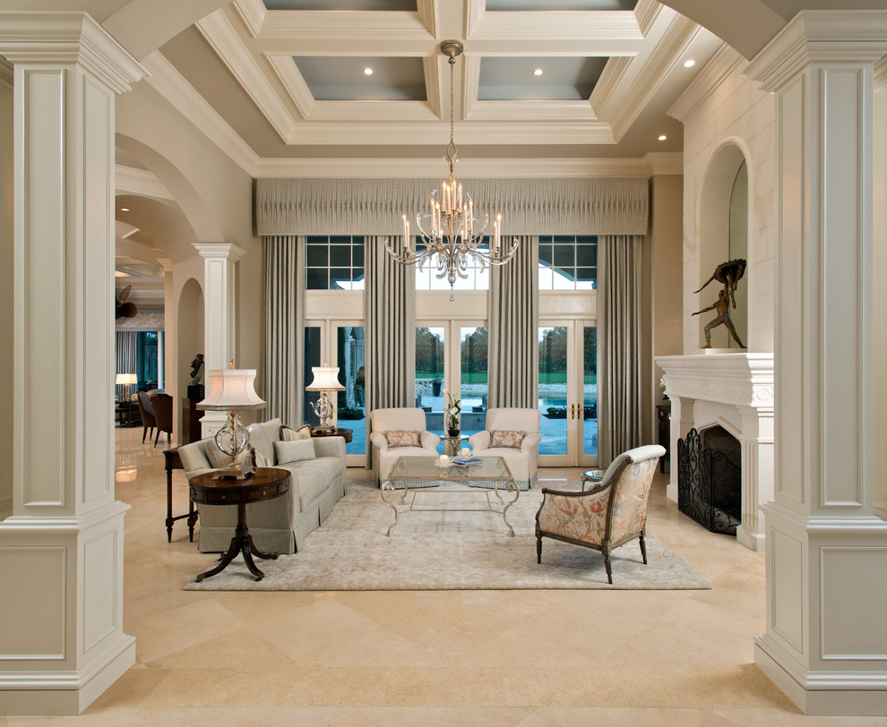 Ispirazione per un soggiorno chic con sala formale, pareti grigie, camino classico e pavimento beige
