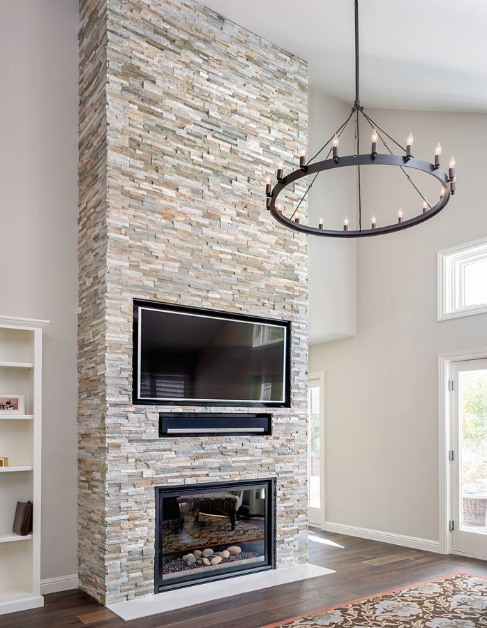 Inspiration for a living room remodel in Other with a stacked stone fireplace