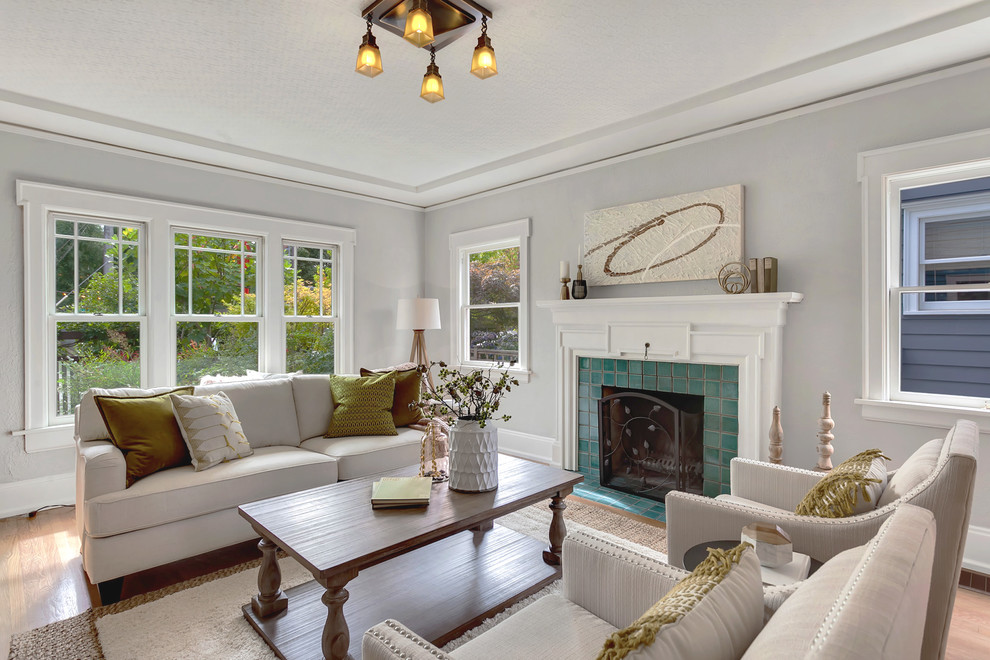 Example of a mid-sized arts and crafts formal medium tone wood floor living room design in Seattle with gray walls, a standard fireplace, a tile fireplace and no tv