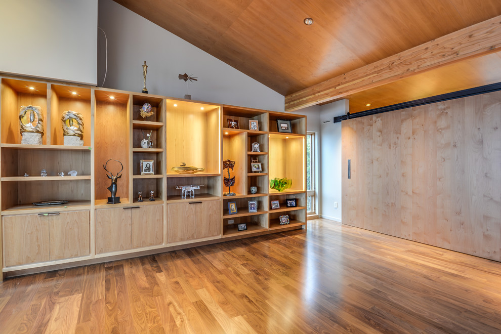Living room - large modern medium tone wood floor living room idea in Seattle with beige walls, a standard fireplace and a wall-mounted tv