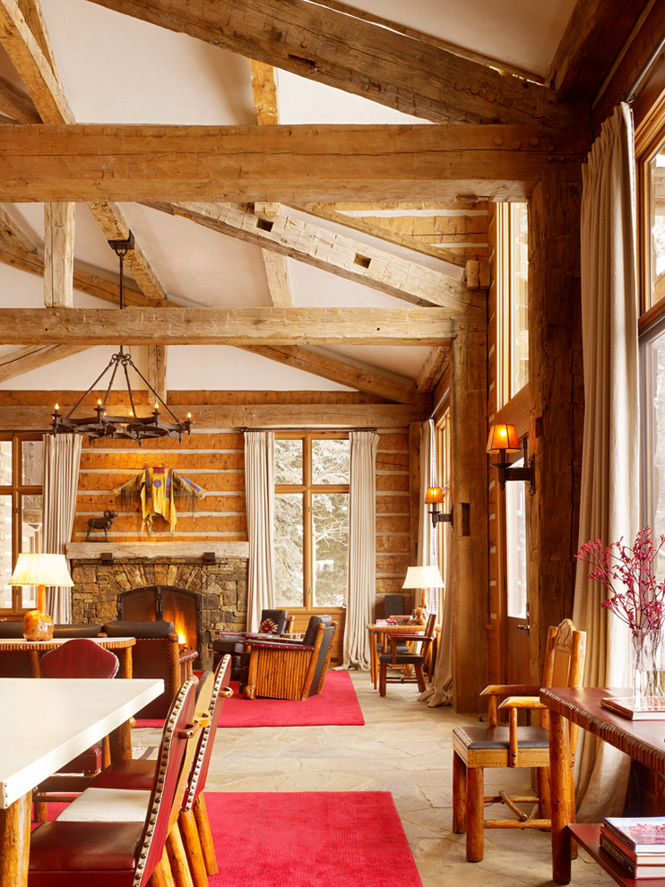 Foto på ett rustikt vardagsrum, med beige väggar, en standard öppen spis och en spiselkrans i sten