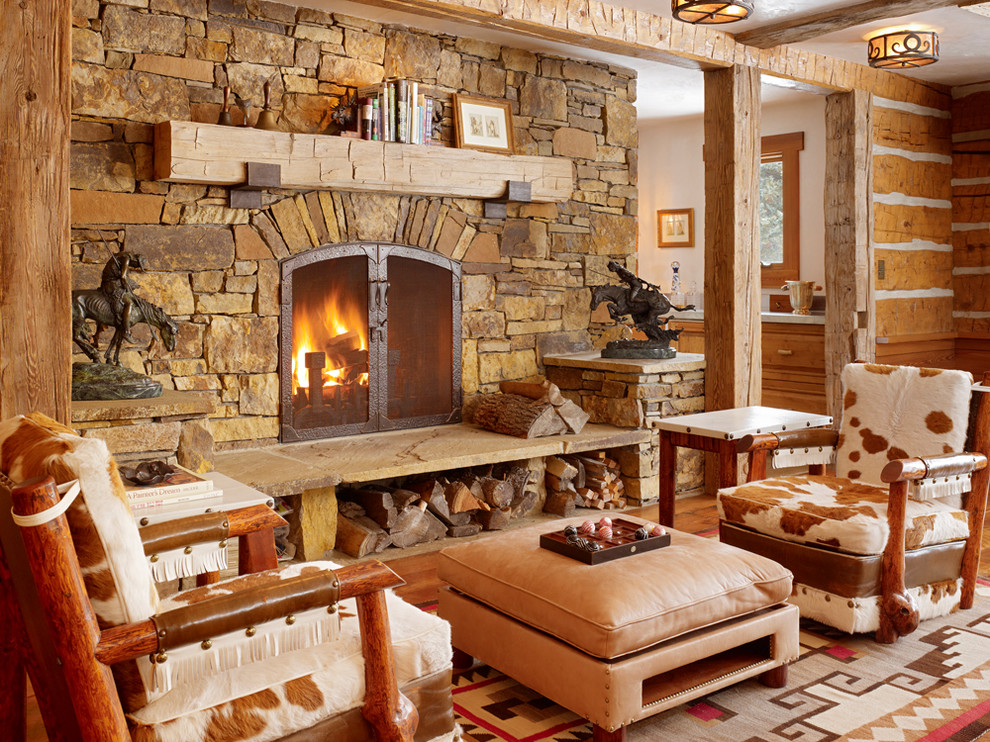 Photo of a rustic living room in Salt Lake City with a standard fireplace and a stone fireplace surround.