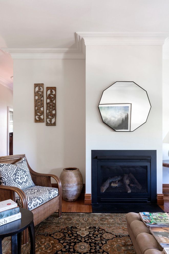 Photo of a medium sized traditional enclosed living room in Sydney with white walls, dark hardwood flooring, a standard fireplace, a metal fireplace surround and no tv.