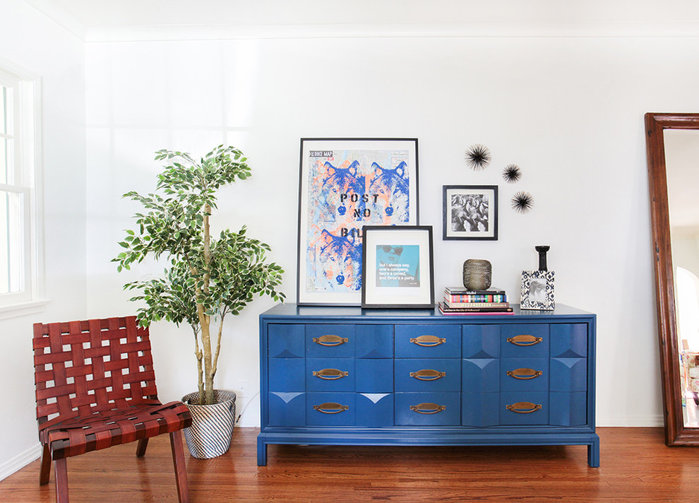 Example of a transitional medium tone wood floor living room design in Los Angeles with white walls, no fireplace and no tv